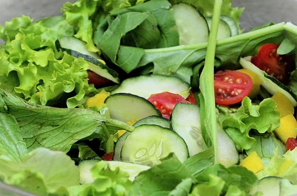 istock Lettuce leaves, arugula, red onion, cherry tomatoes, cucumber and mango for salad 2239669021