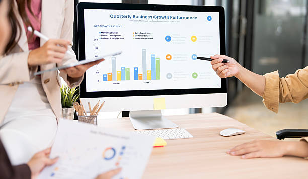 istock A close-up shot of a business team analyzing a digital dashboard displaying quarterly business growth and performance charts. They are using a stylus and a pen to point out key data. 2239669425