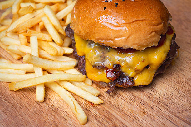 Delicious grilled beef burger with melted cheddar cheese and crispy French fries.