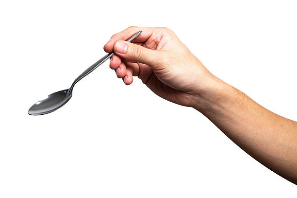 istock Male hand holding a black plastic spoon isolated on white background. 2239671943