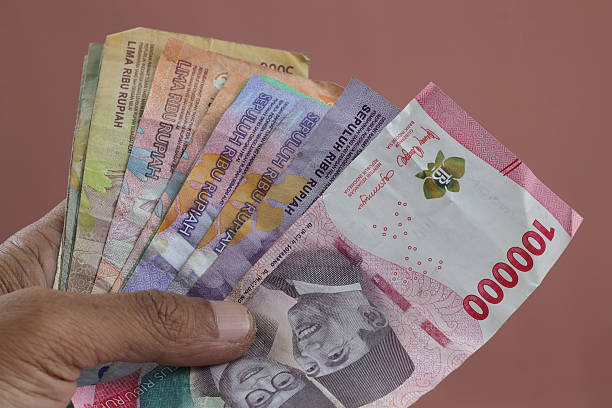 istock Male hand holds Indonesia rupiah 2239672477