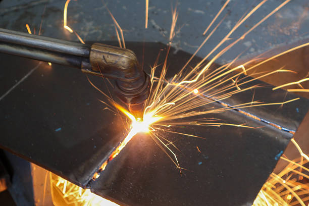 Metal cutting with acetylene and oxygen gas torch,  separated from each other. With a red flame off the brass cutting head And sparks of fire fell out