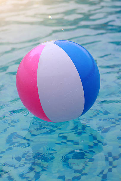 istock Beach ball floating in swimming pool 2239674720