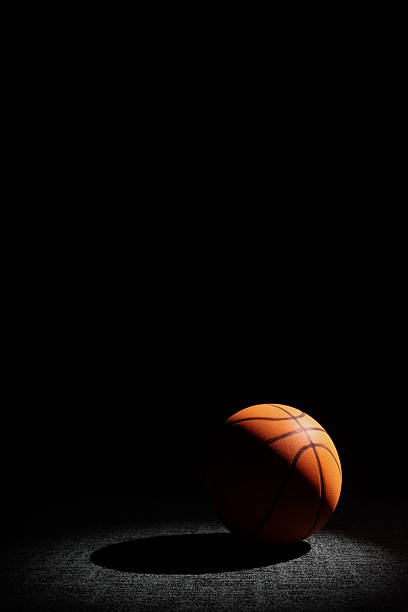 istock Basketball Sitting on a Dark Background 2239677460