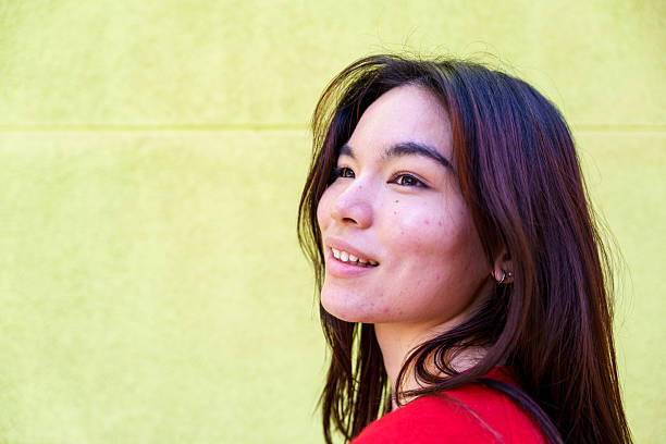 istock Young Japanese woman smiling looking up 2239681082