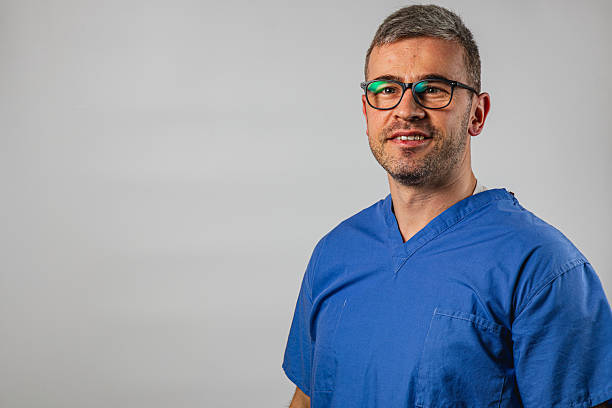 istock Doctor in blue scrubs smiling confidently in a clinical setting 2239681576