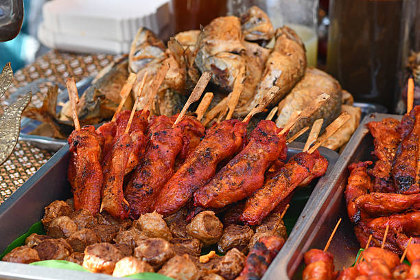 istock Red marinated Thai chicken meat skewers at 2239685692