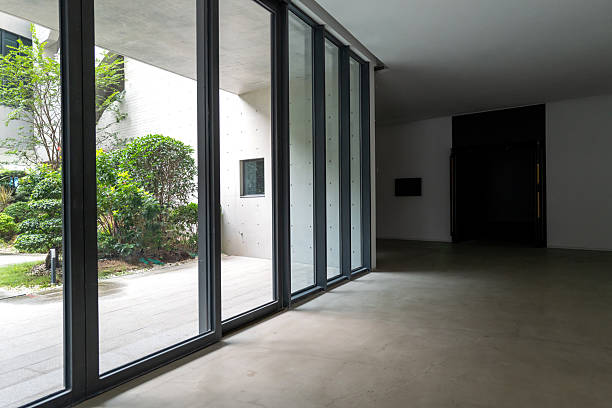 istock Open indoor three-dimensional space, glass sliding doors with concrete grey walls 2239686762