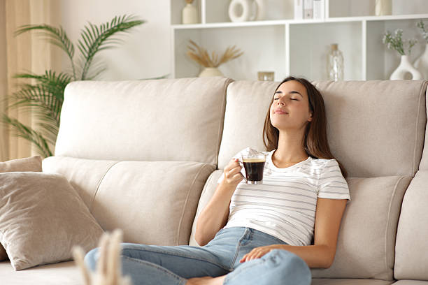 istock Relaxed woman resting on a couch holding coffee cup 2239687437
