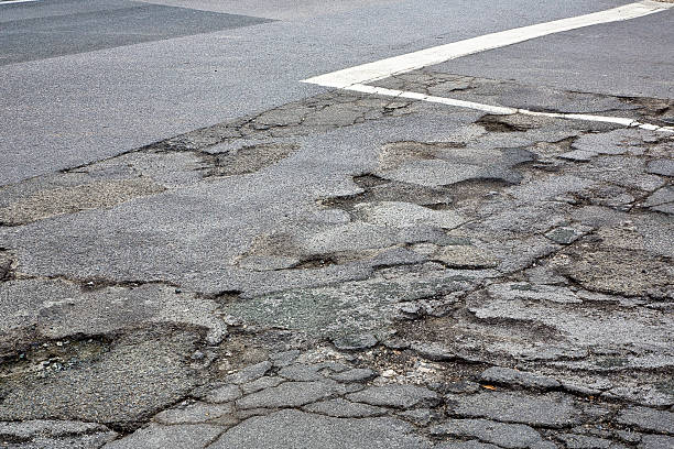 istock Old broken, cracked and damaged asphalt road - Danger for motorists and cyclists 2239688024