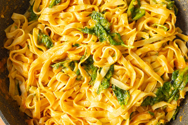 istock pumpkin tagliatelle pasta with fresh spinach in a pan, perfect for a cozy fall dinner 2239688163