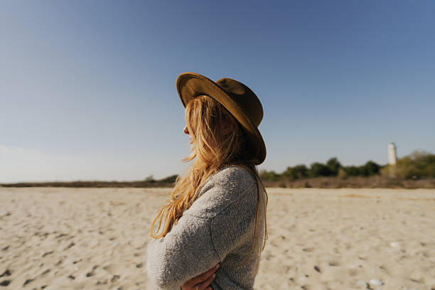 istock Catching some autumn sun on the beach 2239690010