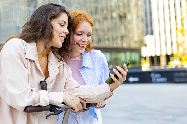 istock Two young women friends having fun sharing smartphone content 2239690259