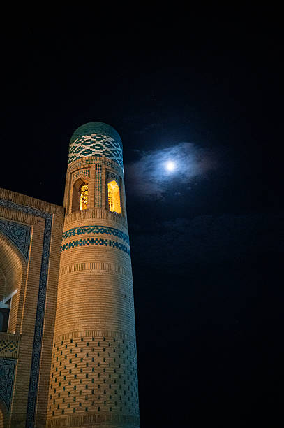 istock Ancient Minaret Illuminated Under Full Moon in Khiva, Uzbekistan 2239691057