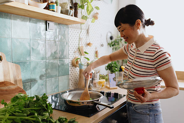 istock Woman stirring vegetables in a frying pan 2239693469
