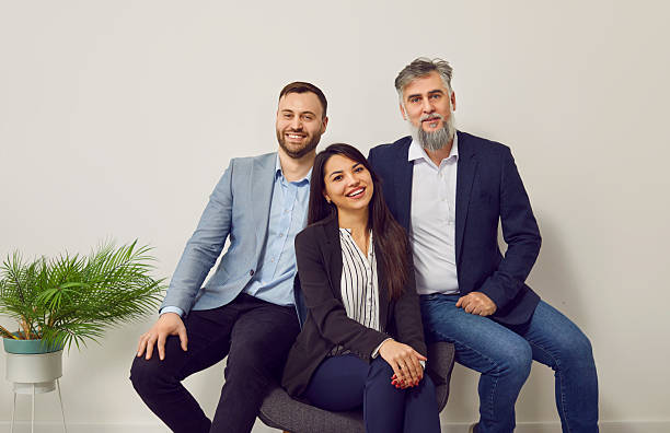 istock Group of smiling business workers posing together in office 2239694436
