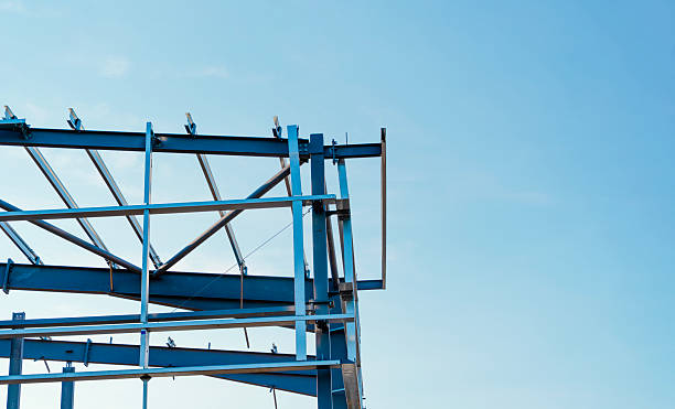 istock Corner of the steel frame structure under construction against blue sky 2239696677