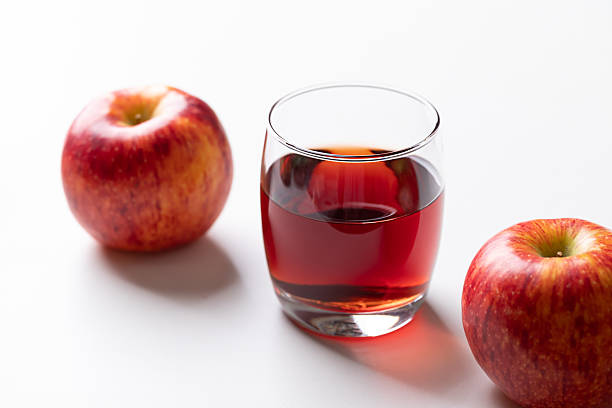 istock Glass of apple cider with red apple fruit on white background 2239697180