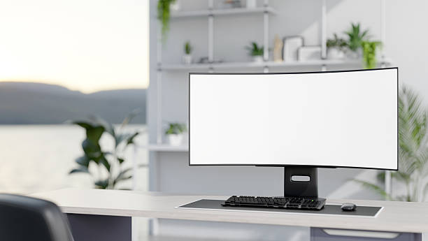 istock Blank screen computer on wooden table in a bright white room with green potted plants and decor item 2239699608
