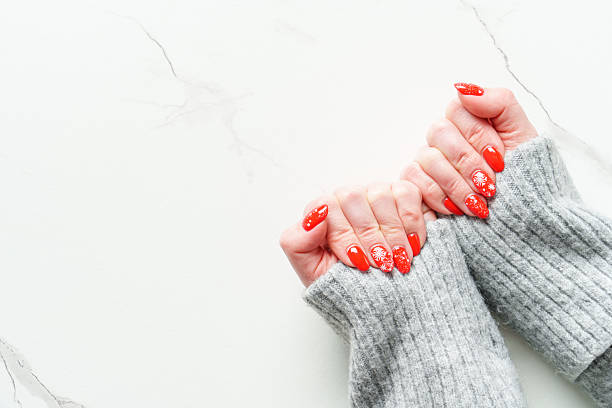 istock Christmas manicure, Beatiful red nails on white background. 2239700383