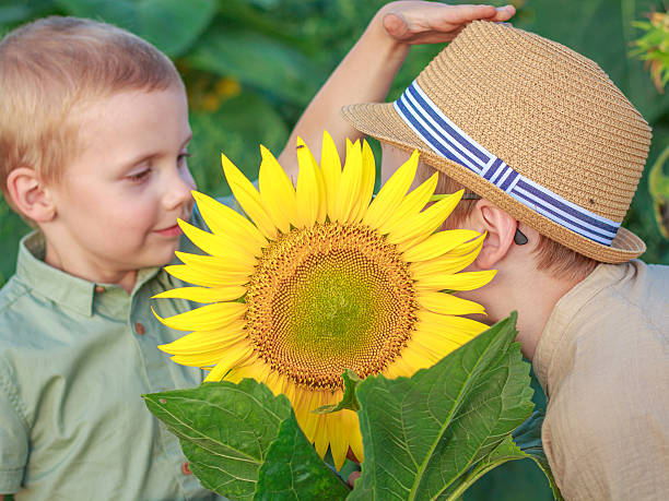 Happy mother with the daughter in the field with sunflowers. mom and baby girl having fun outdoors. family concept.