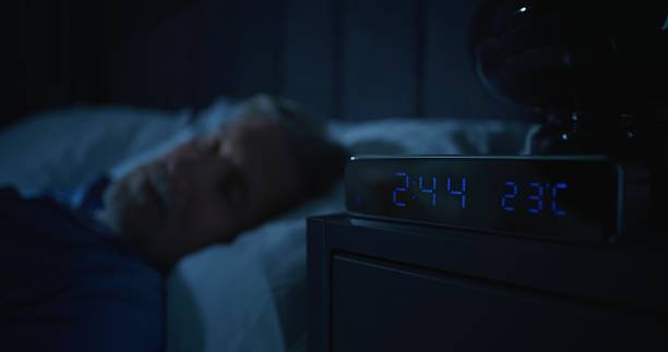 istock Restless Man in Dark Bedroom, Digital Clock Glowing at Two AM 2239702497