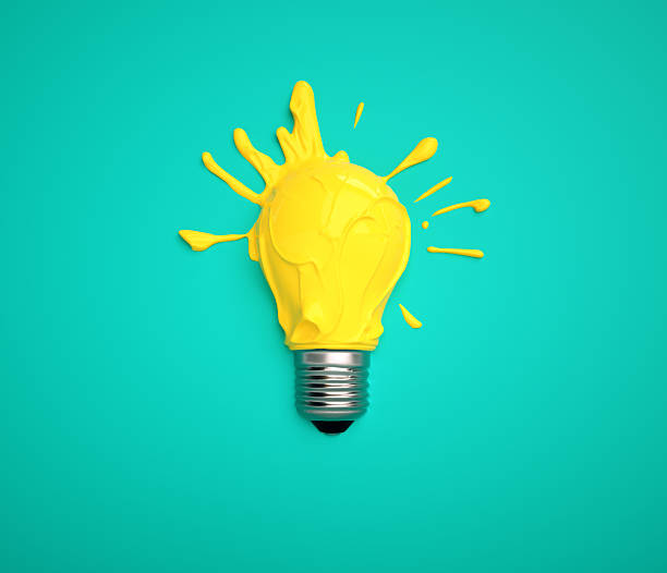 istock Bright yellow paint splashes from a light bulb against a teal background in a creative artwork display 2239703071