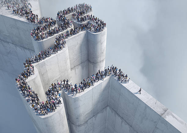istock Crowds gather at the edge of a massive concrete structure surrounded by fog in a surreal setting 2239703117