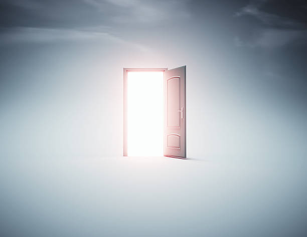 istock Mysterious open door revealing bright light in a surreal empty space creates a sense of wonder and curiosity 2239703212