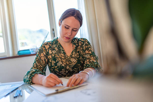 istock Painter artist young woman in her home studio: Drawing on table 2239703291