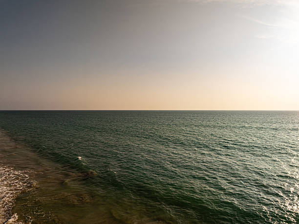 istock Beautiful sky sunset or sunrise clouds over sea nature background 2239703346