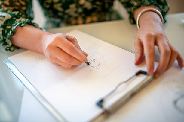 Painter artist young woman in her home studio: Drawing on table