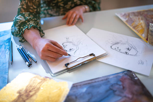 Painter artist young woman in her home studio: Drawing on table