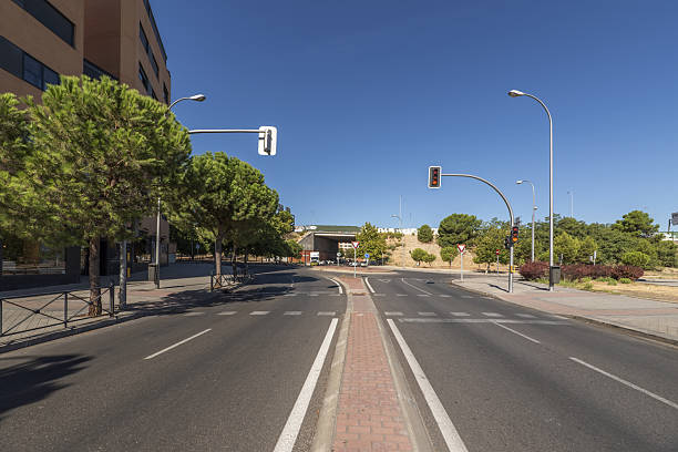 istock A two-way street with a large tree-lined roundabout 2239704186