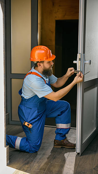 istock Technician fixing metal door lock in modern office building 2239705735