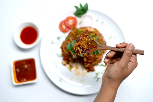 Spicy Kottu Roti Dish tasting with spoon. closeup image.