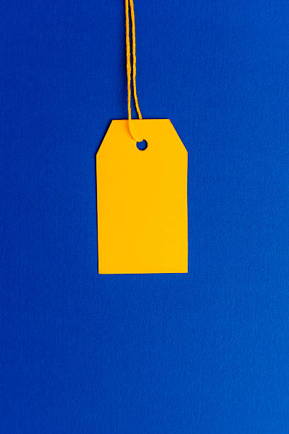 istock Yellow price tag on blue background minimal top view 2239709689