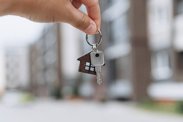 istock man hand with metal key 2239710056