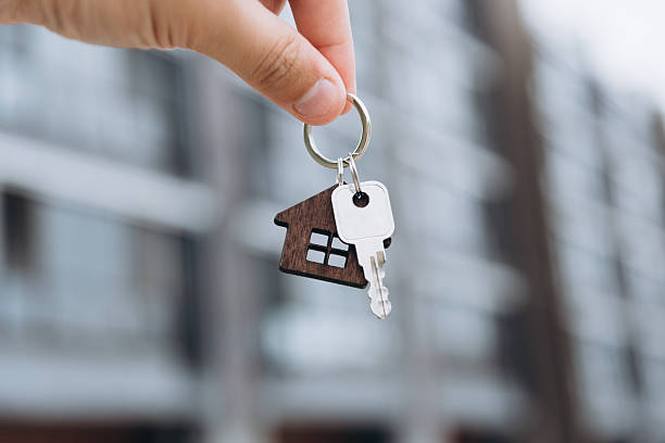 istock man hand with metal key 2239710079
