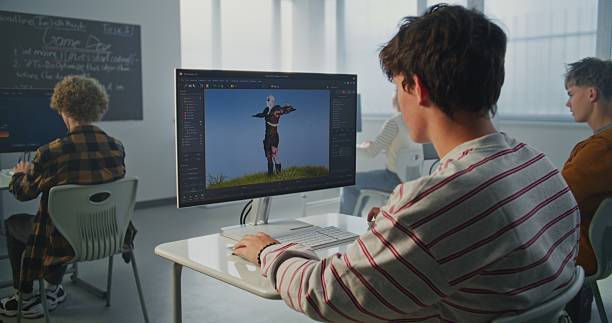 istock Student in Striped Sweatshirt Creates 3D Animation on Computer in Modern Classroom 2239710080