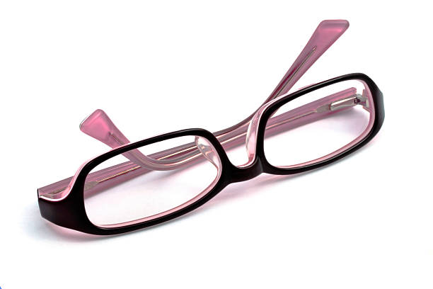 Modern glasses lie on the table against the light. dark mood. copy space