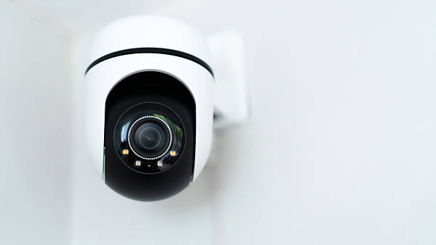 istock A camera is mounted on a wall. The camera is a dome shaped camera. The camera is black and white 2239715508