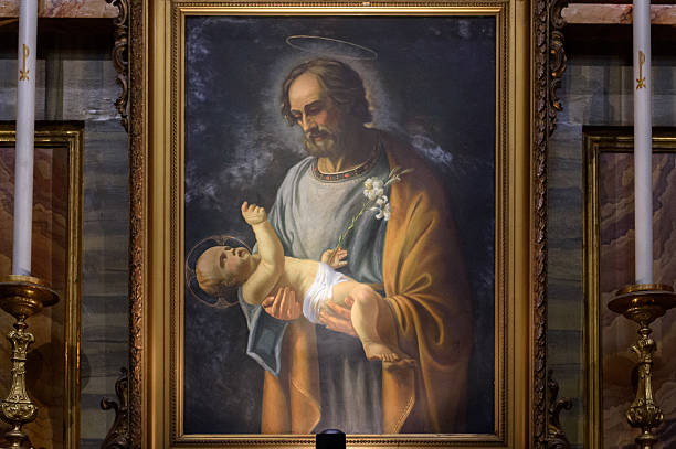 Rome, Italy - August 25, 2025: Church of the Twelve Holy Apostles. Dedicated originally to St. James the less and St. Philip whose relics are kept here, and later to all Apostles. In this photo, the painting of St Joseph and Jesus Baby by minor friar Cianci Antonio (1924 around).