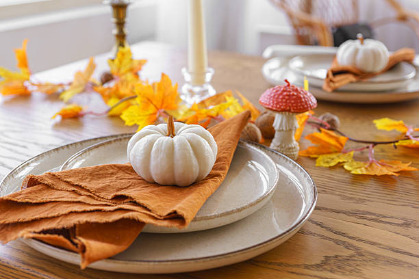 istock Autumn, fall, Halloween or thanksgiving festive day table setting with yellow leaves and pumpkins 2239718049