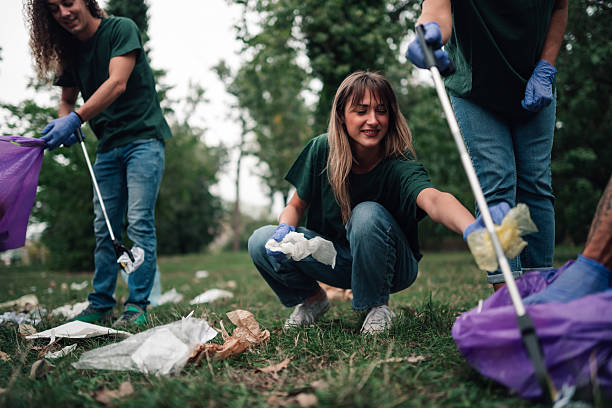 istock Community volunteers collecting trash in a park environment 2239718193