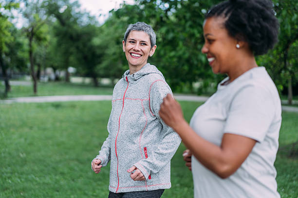 istock Friends talking and running in the public park. 2239718841