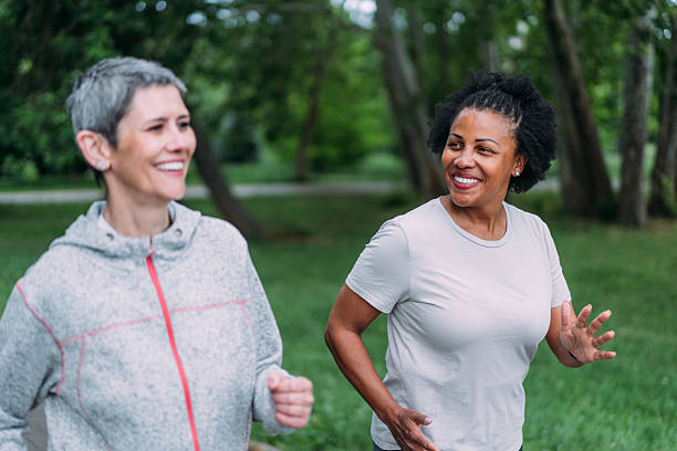 istock Friends talking and running in the public park. 2239718843