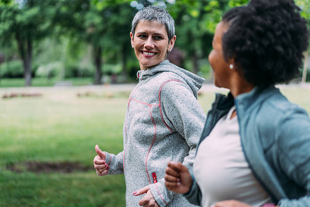 istock Friends talking and running in the public park. 2239718854