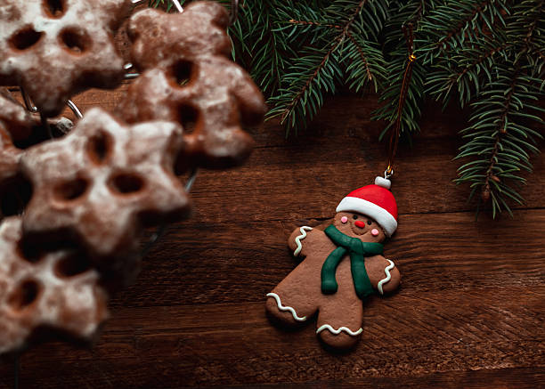 Christmas holiday concept with gingerbread man toy on a wooden background. Christmas tree toy.