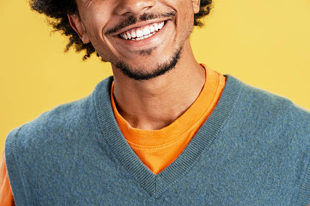 istock Young man smiling showing perfect white teeth 2239722327